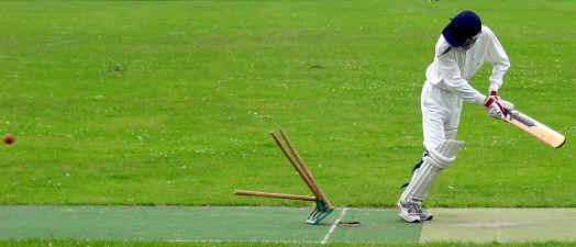 Missed it: Andrew Wardle of Old Fallopians watches the stumps fly after an 008 delivery